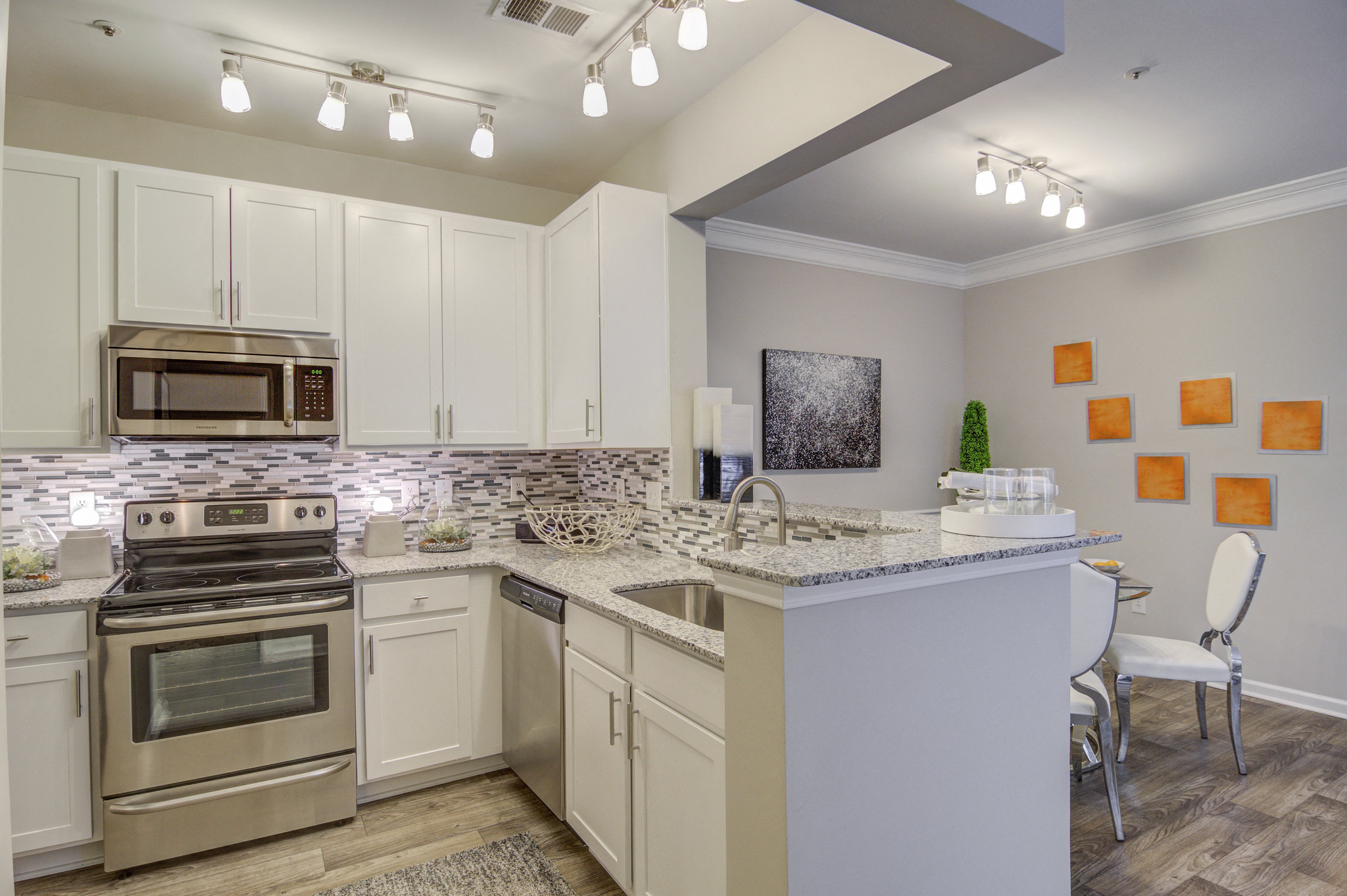 a spacious kitchen with stainless steel appliances and granite counter tops