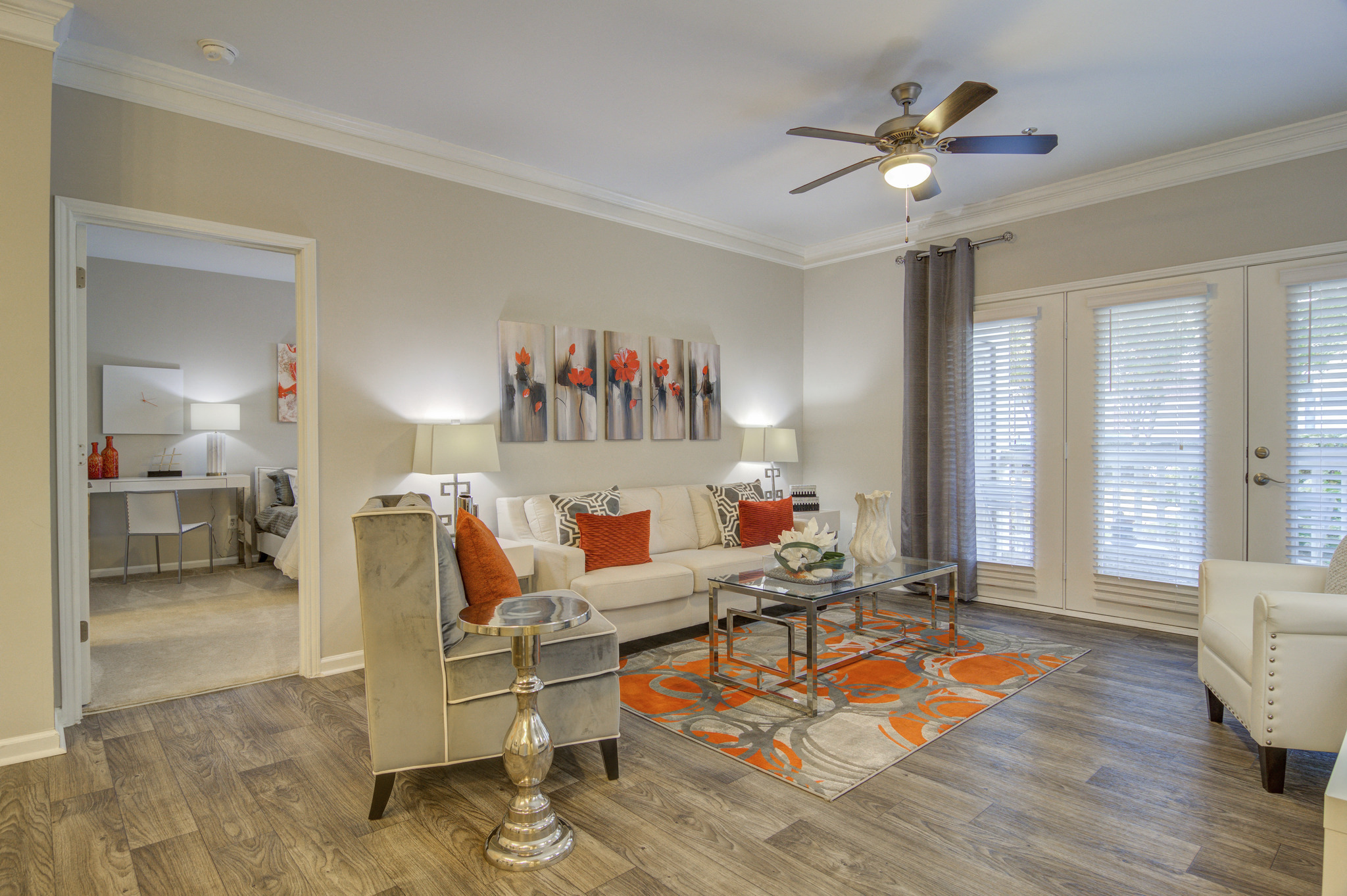 a living room with a ceiling fan and a couch