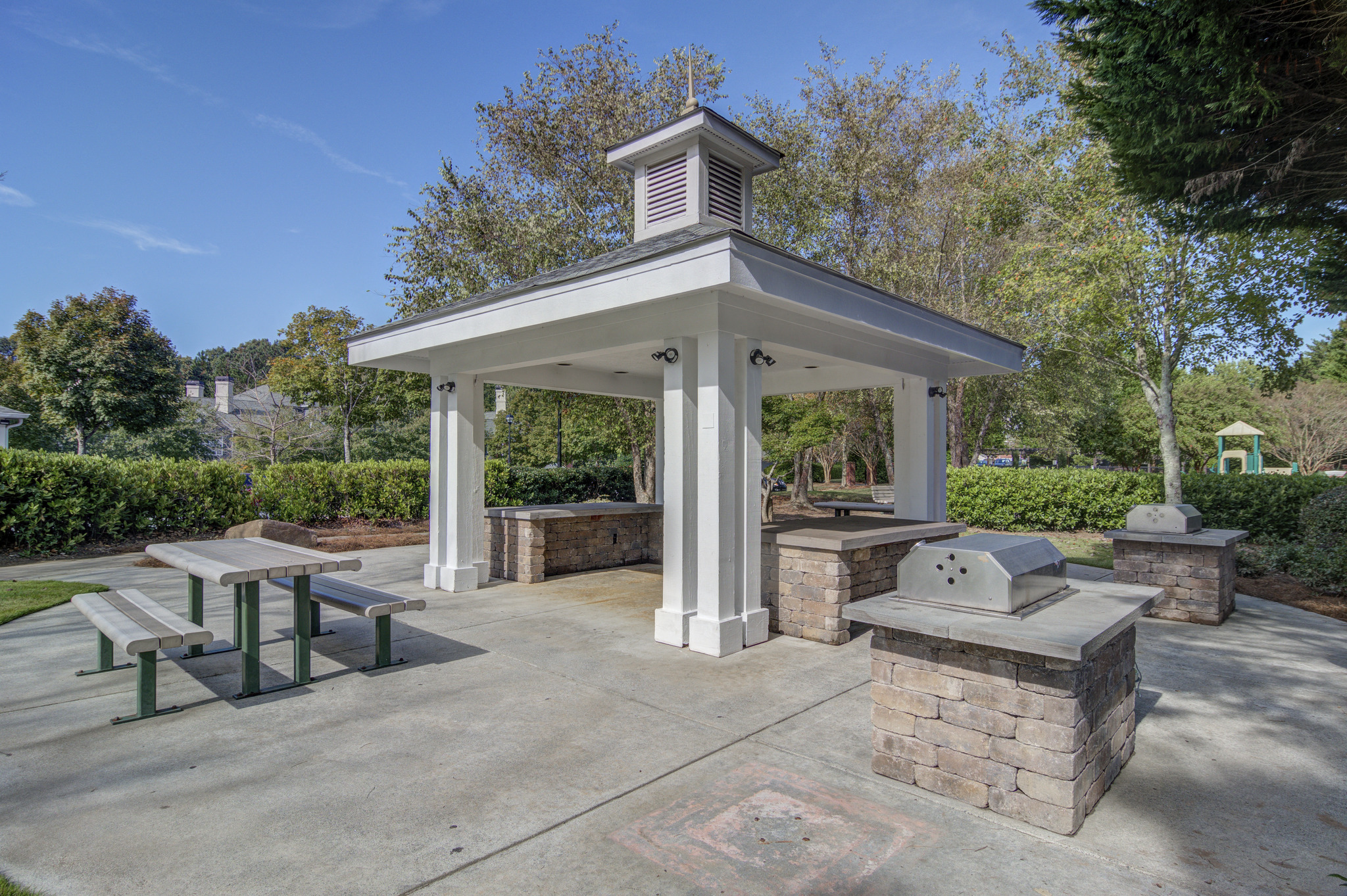 a pavilion with a picnic table and a fire pit