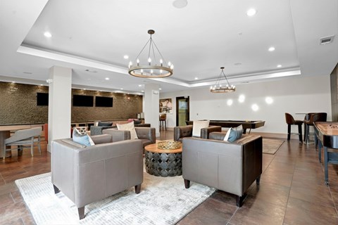 A modern living room with a grey sofa set and a wooden coffee table.