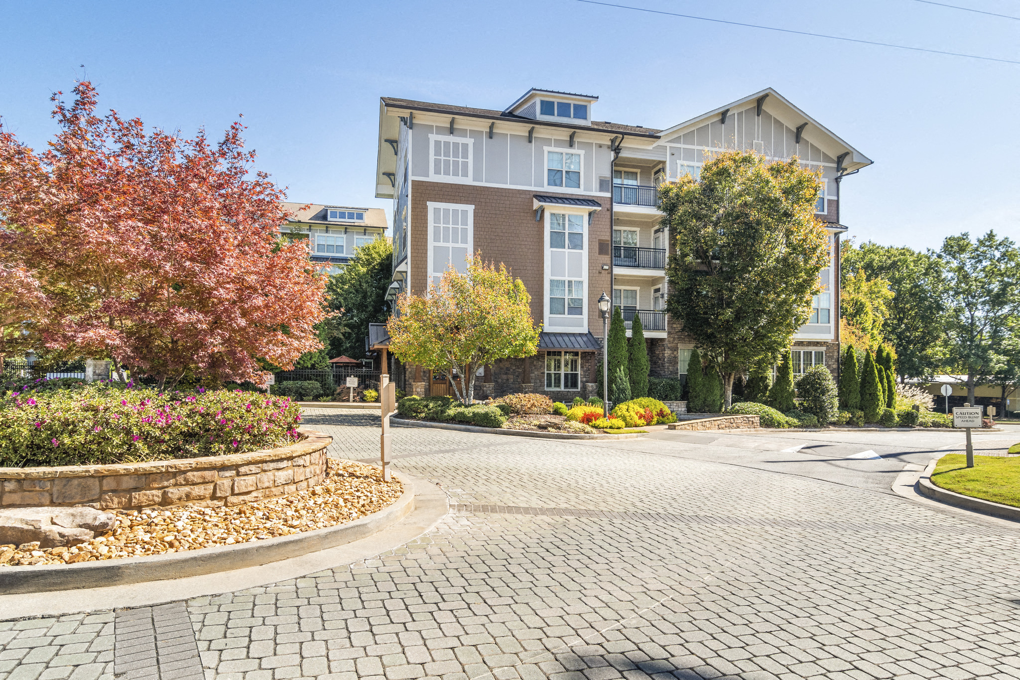 an empty street with an apartment building in the background