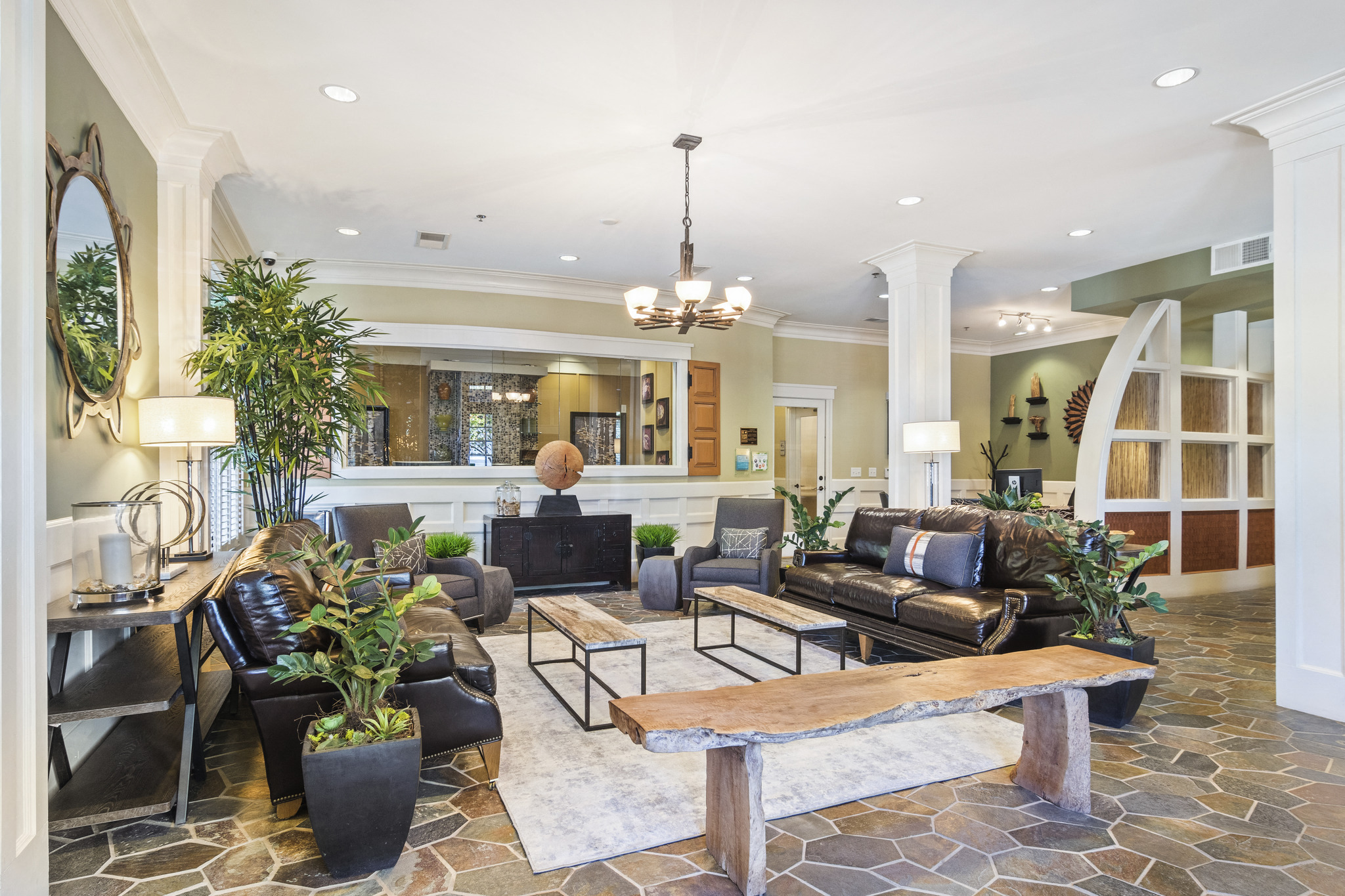 a living room with couches and chairs and a table