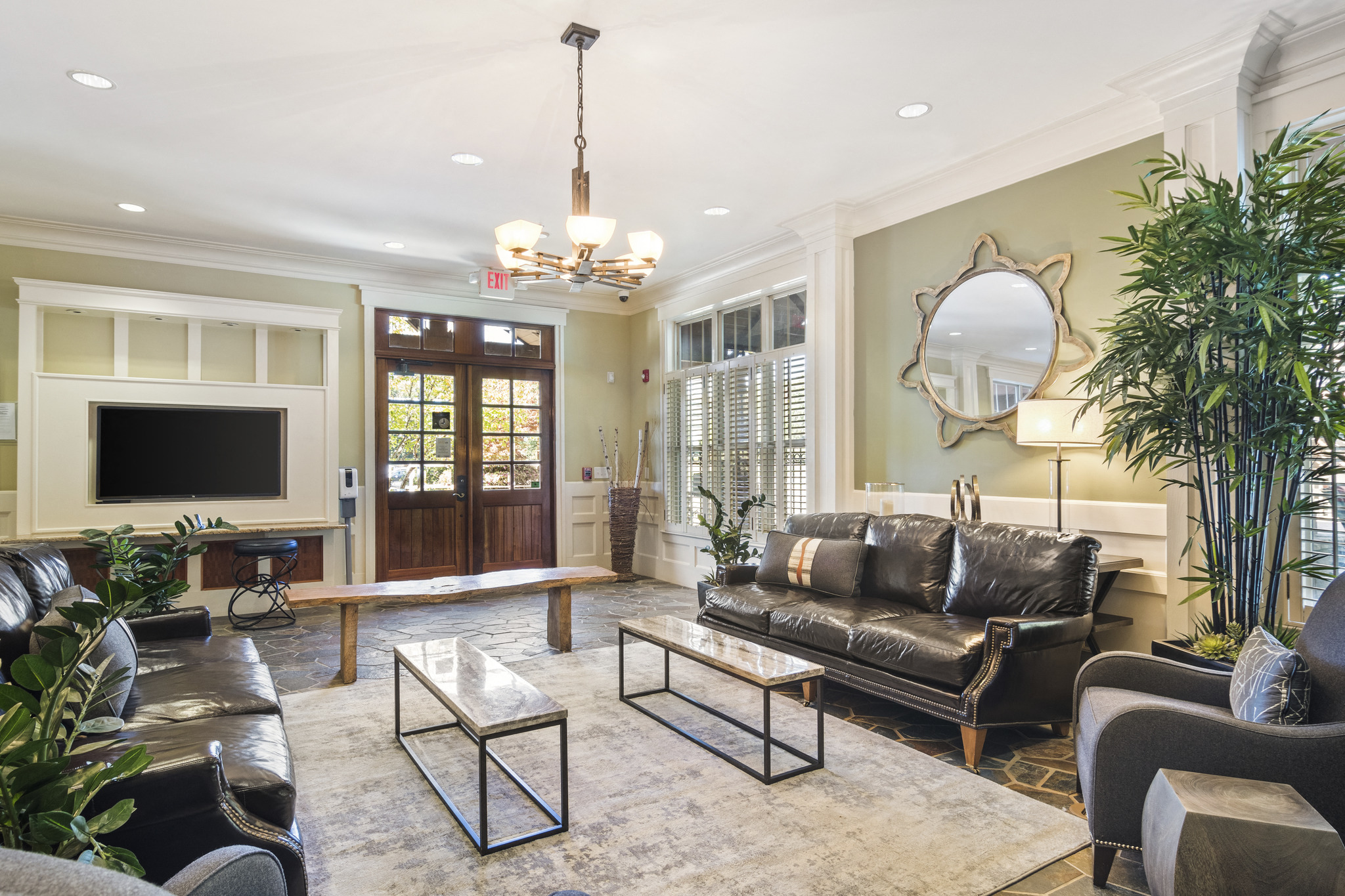 a living room with leather furniture and a television