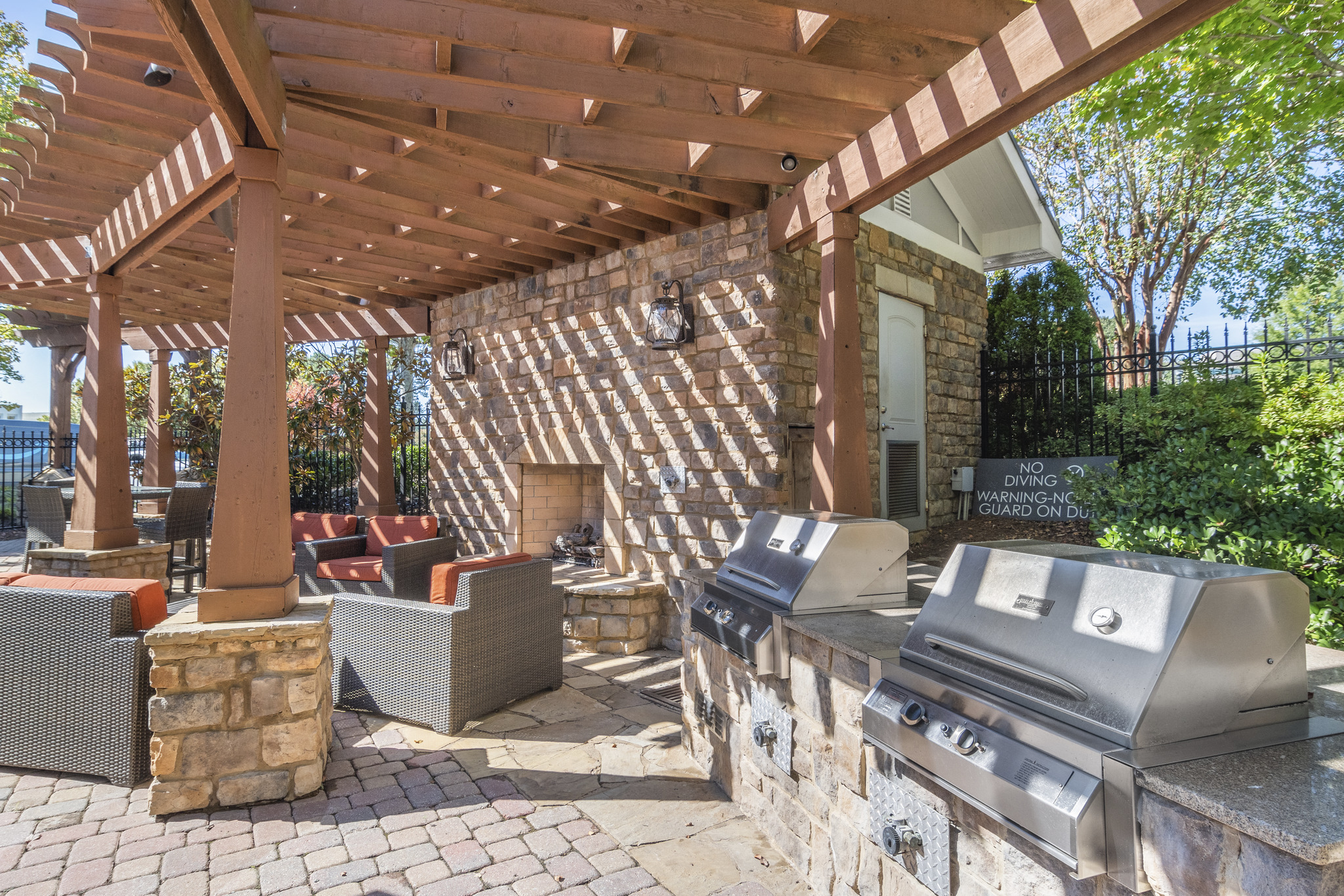 a patio with a grill and a pergola