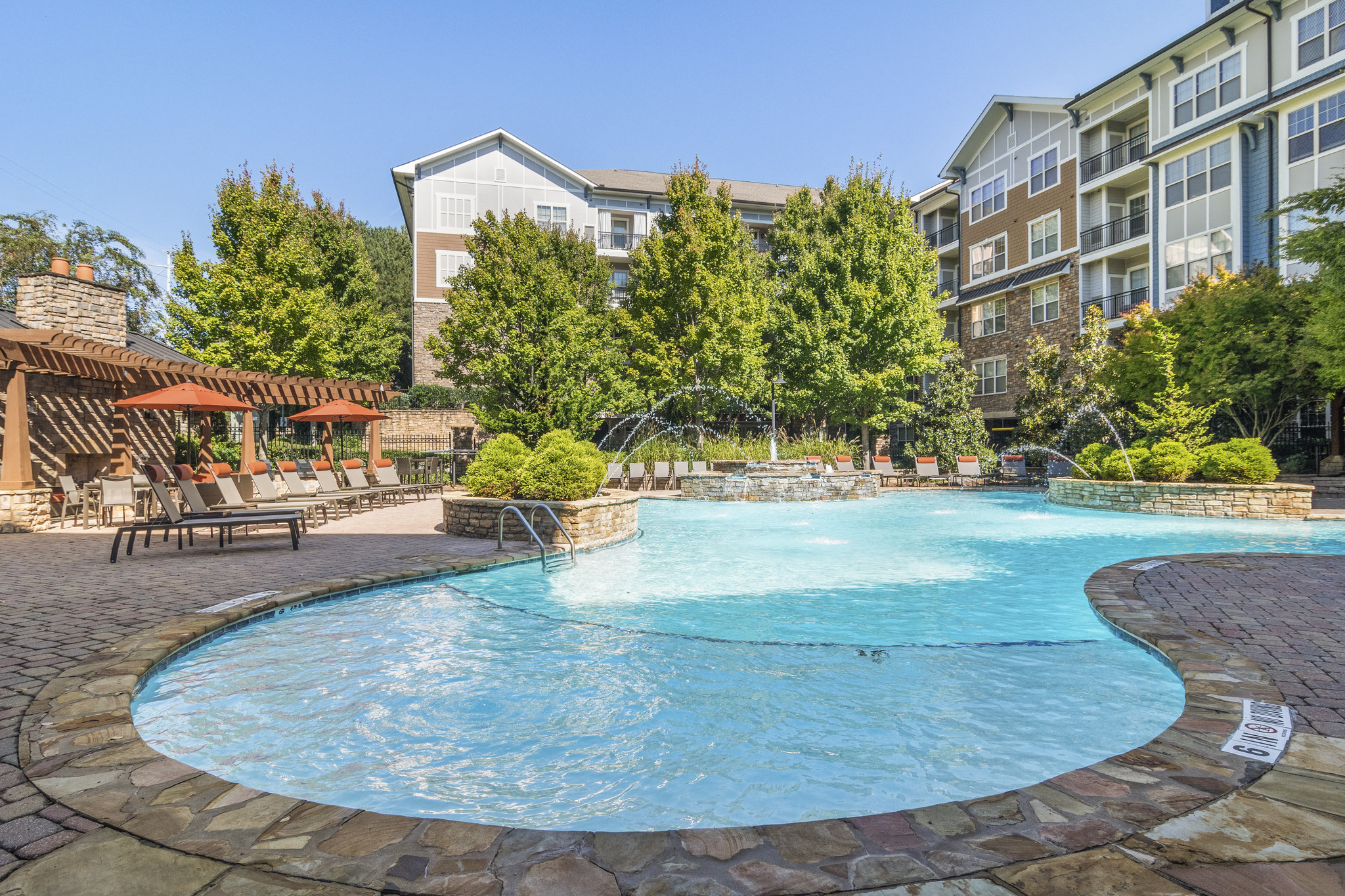 a swimming pool with a hotel in the background