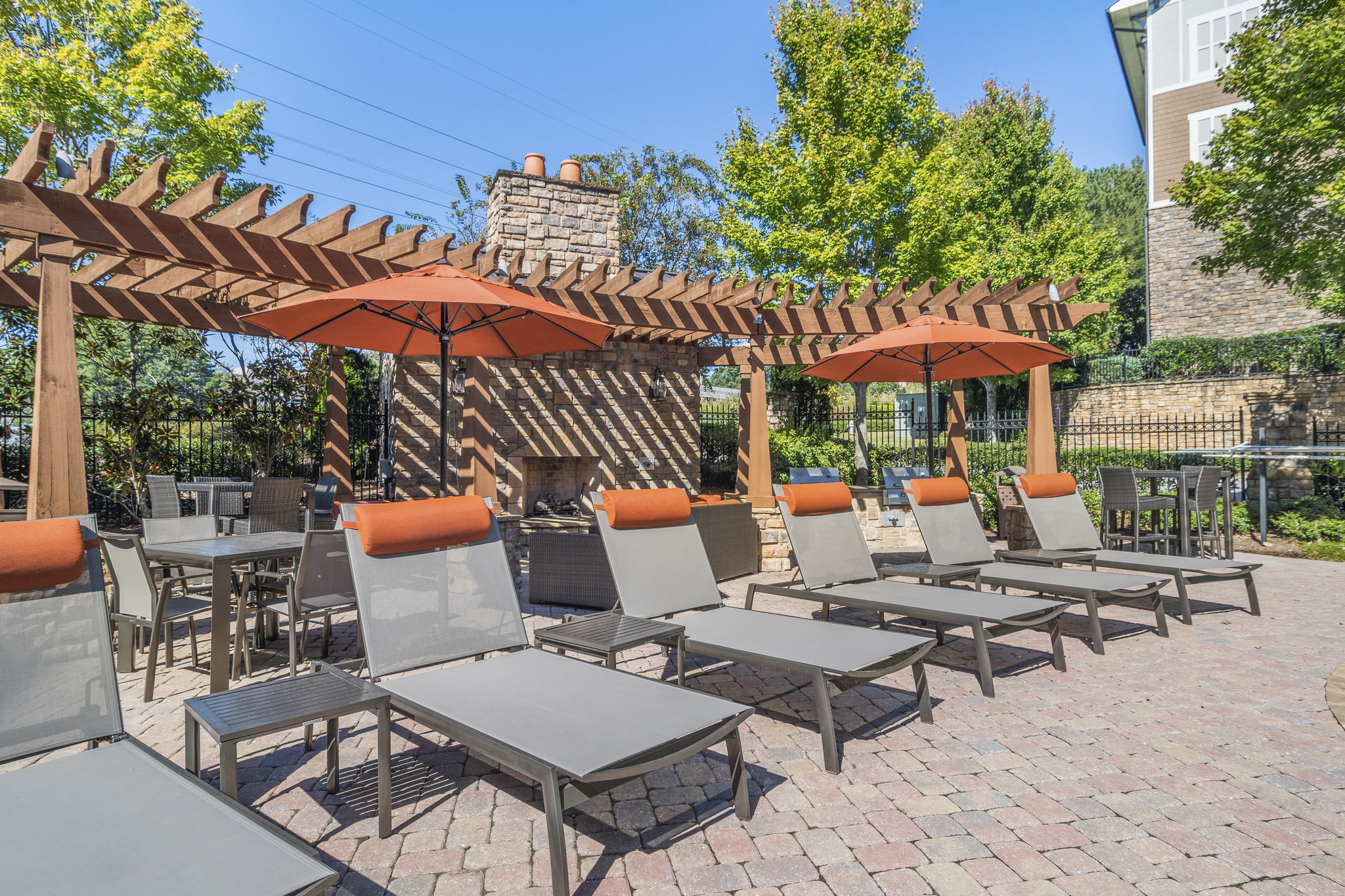 a patio with tables and chairs and umbrellas