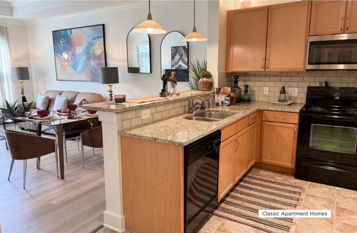 A kitchen with wooden cabinets and a granite countertop.