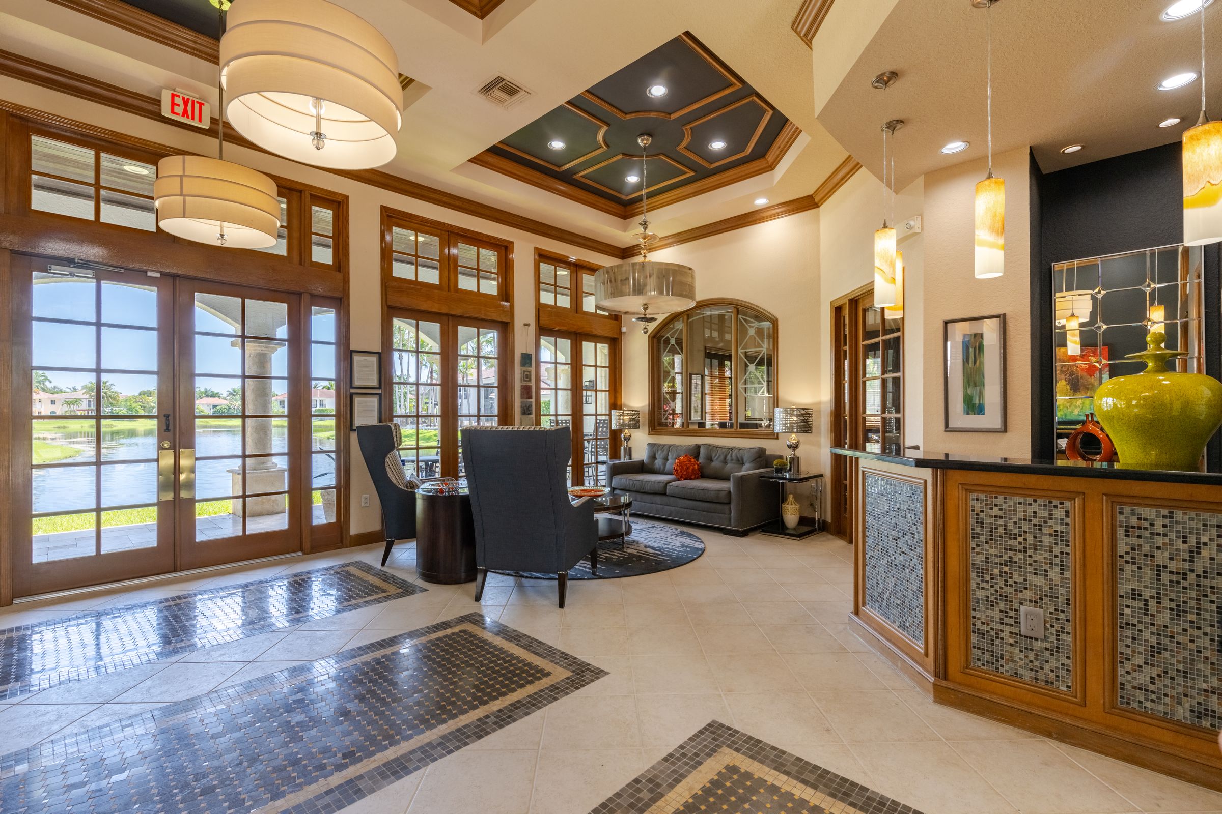 the lobby of a hotel with chairs and a reception desk
