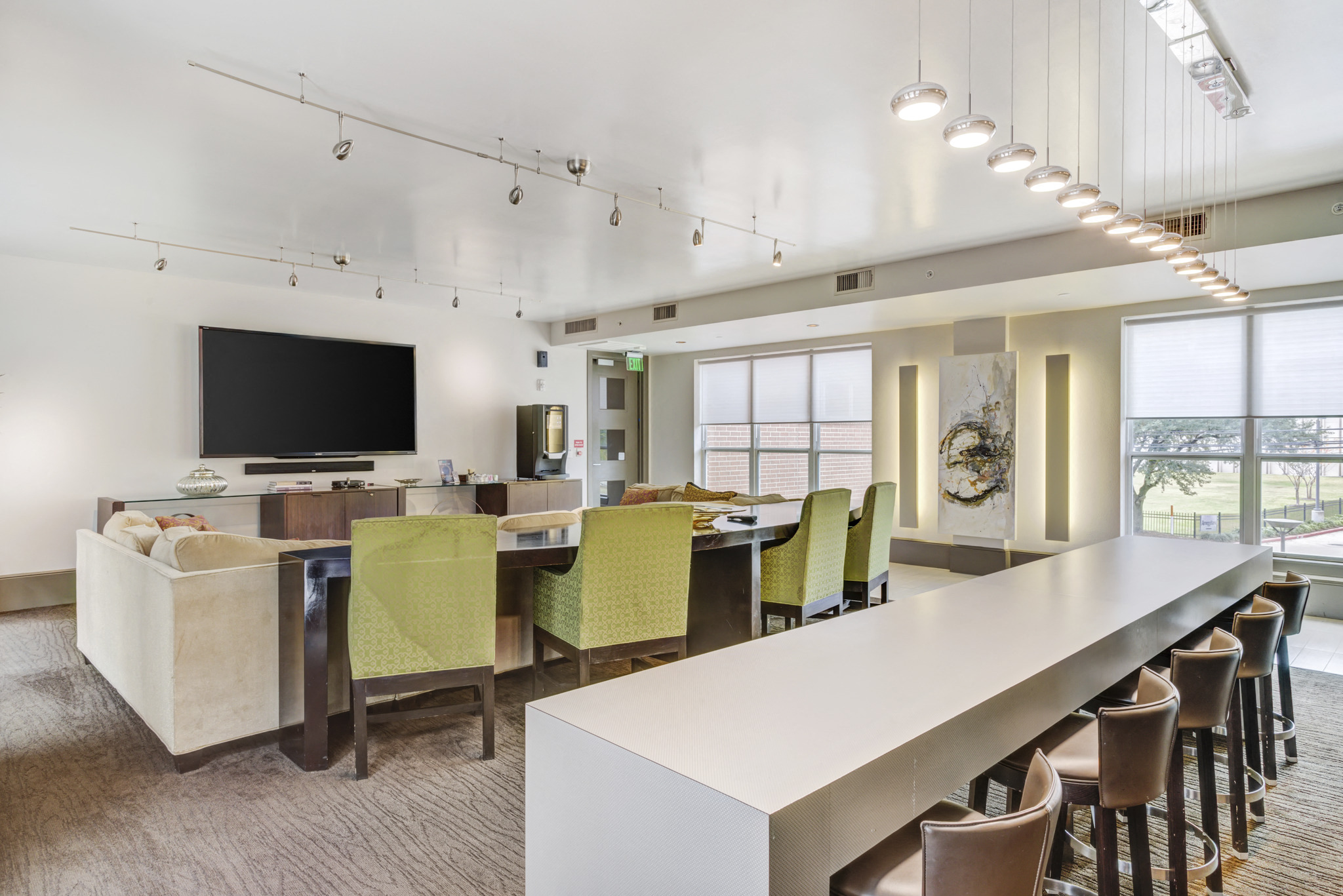 a conference room with a long table and chairs and a television