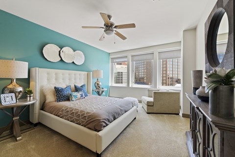 a bedroom with a bed and a ceiling fan