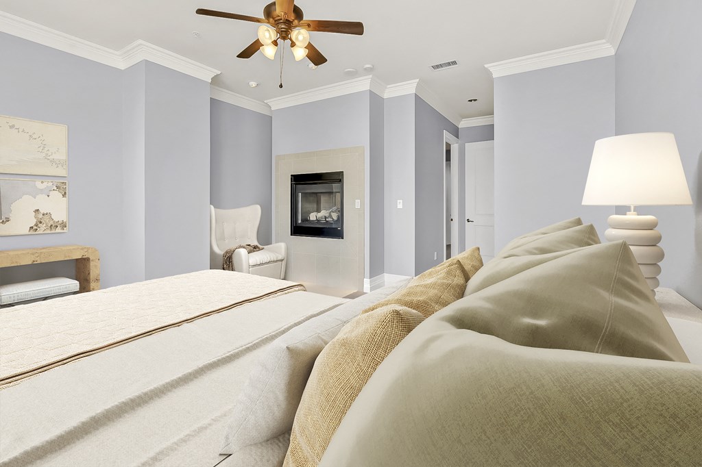 a bedroom with a large bed and a ceiling fan