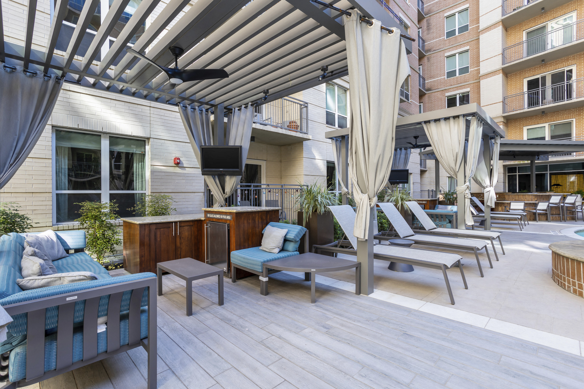 a patio with chairs and a table and a tv