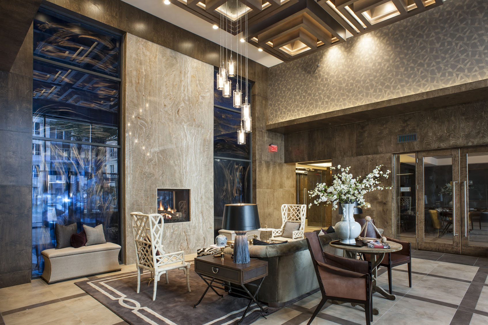 a lobby with a table and chairs and a fireplace