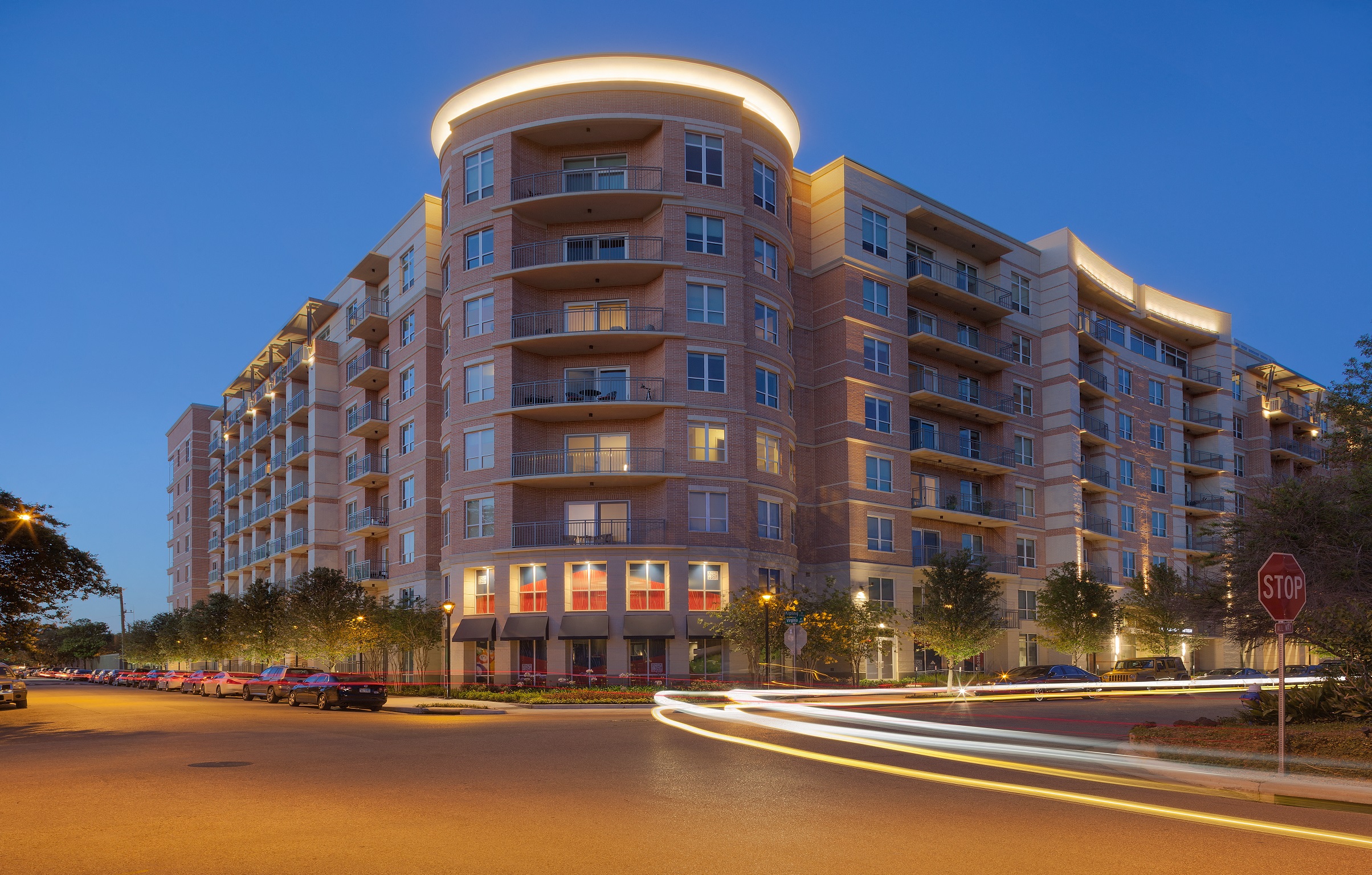 a city street with a large building at night