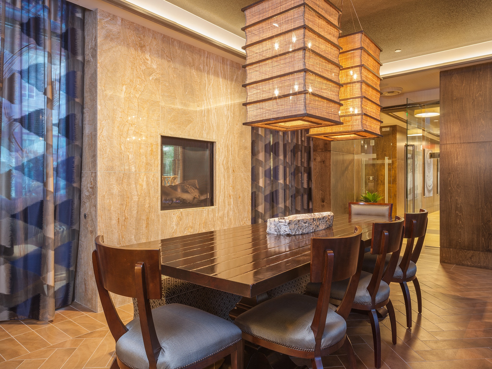 a dining room with a wooden table and chairs and a chandelier