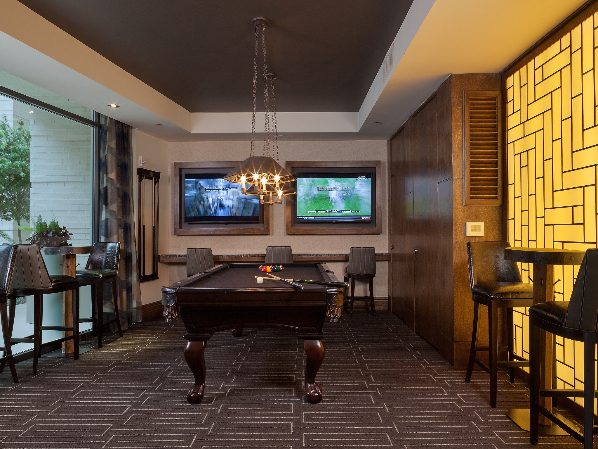 a game room with a pool table and a tv