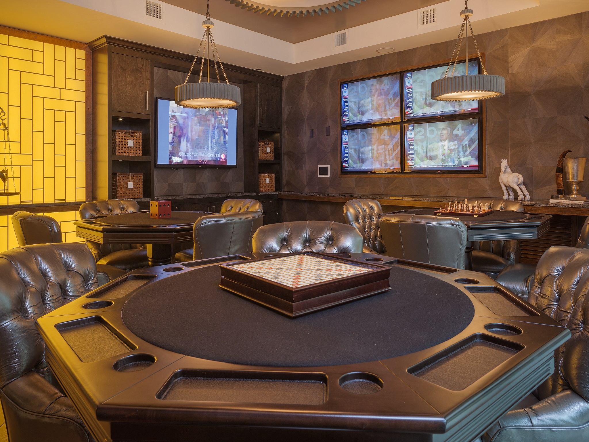 a poker table in a room with chairs and a tv