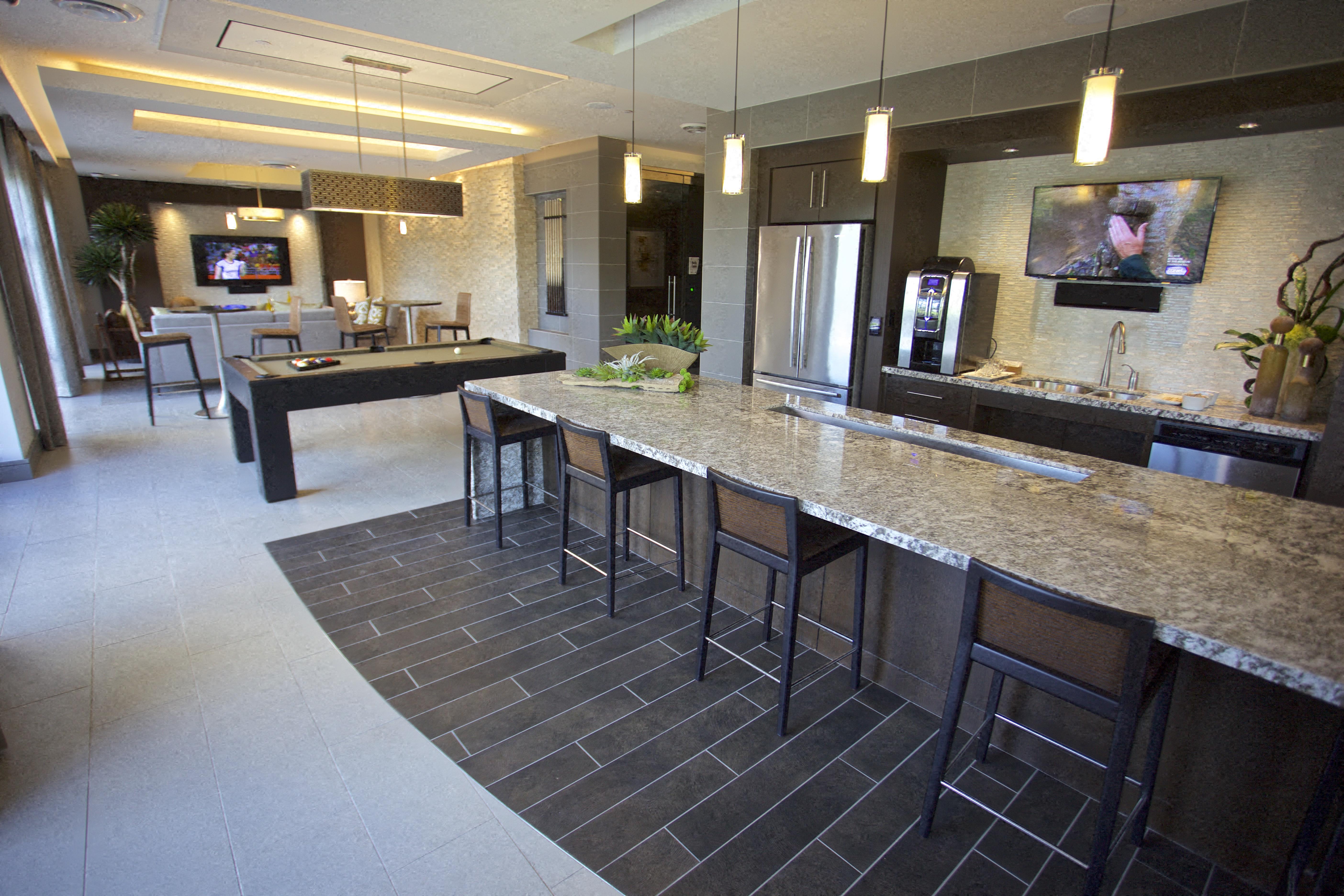 a large kitchen with a bar and a living room