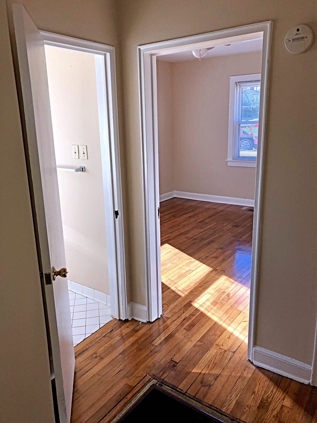 a room with a hard wood floor and an open door