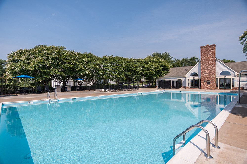 a swimming pool with a house in the background