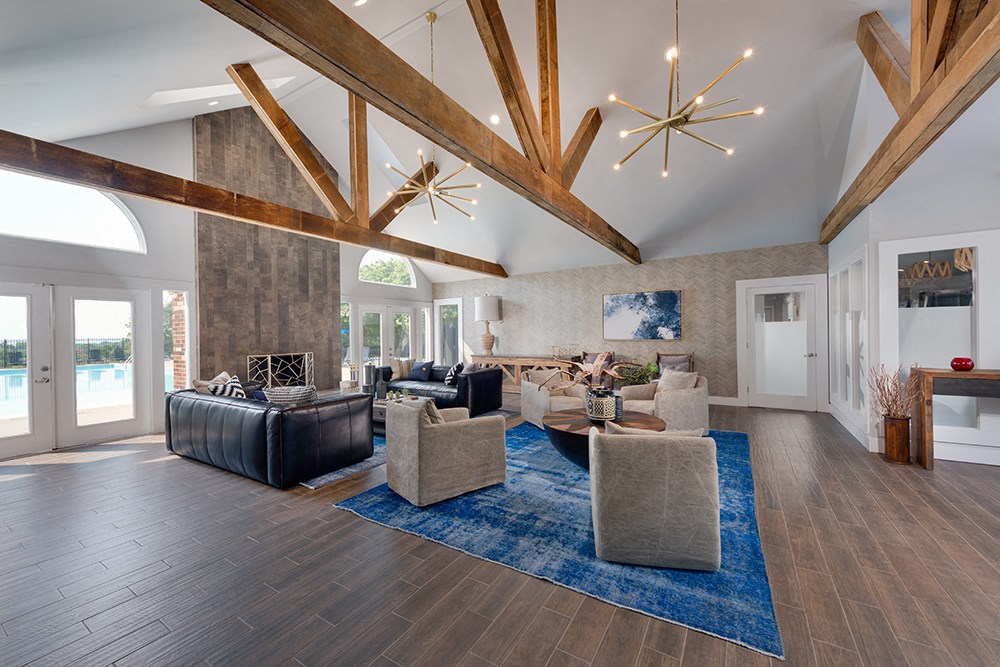 a living room with couches and chairs and a rug