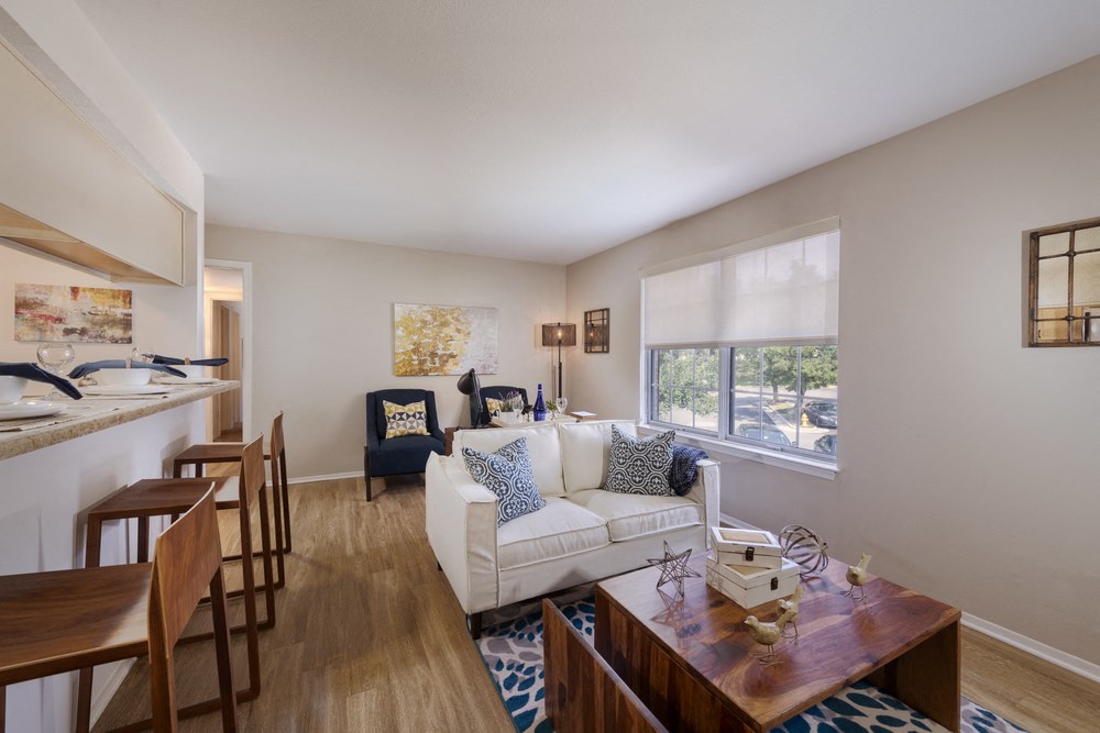 a living room and dining room with a couch and a table