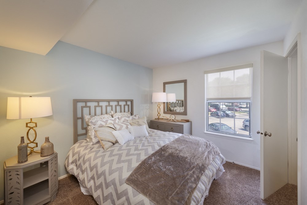 a bedroom with a bed and a window