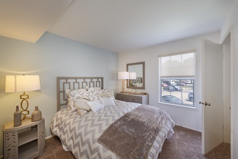 a bedroom with a bed and a window