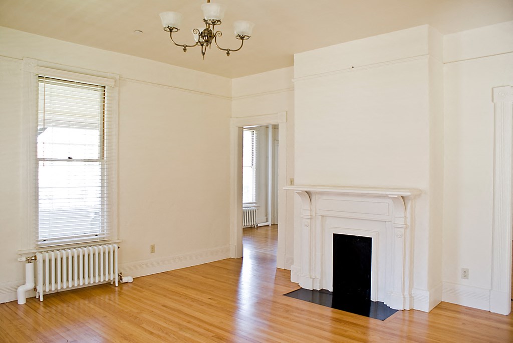 a living room with a fireplace and a wooden floor