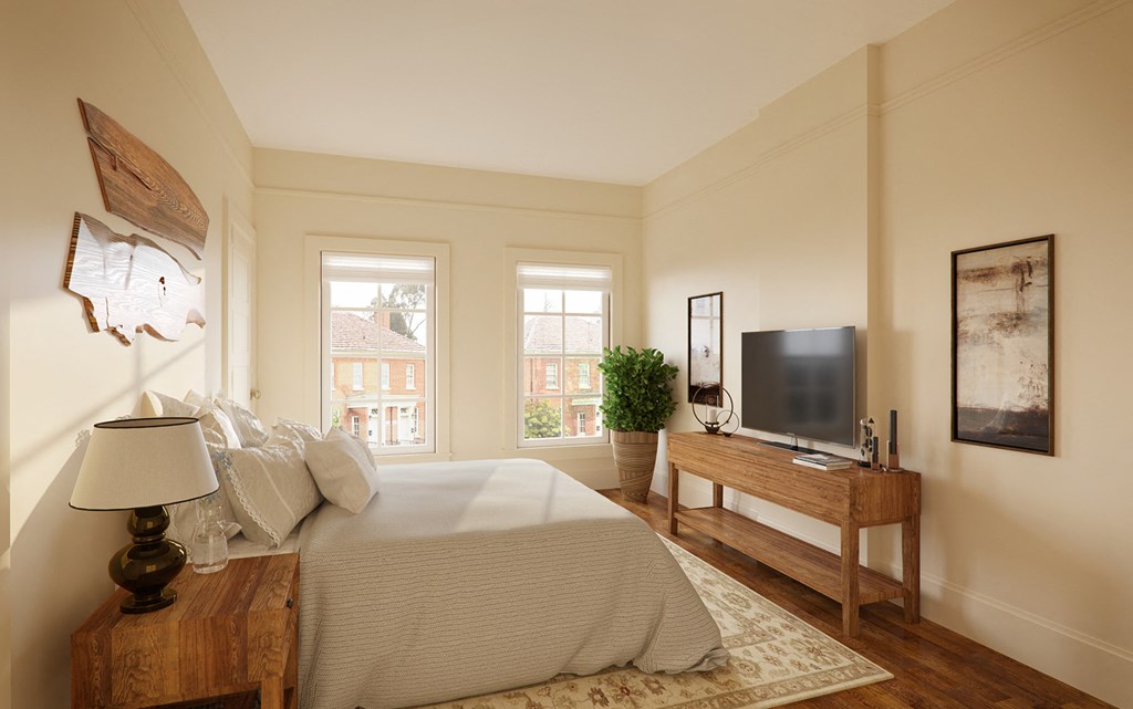 a bedroom with a bed and a television