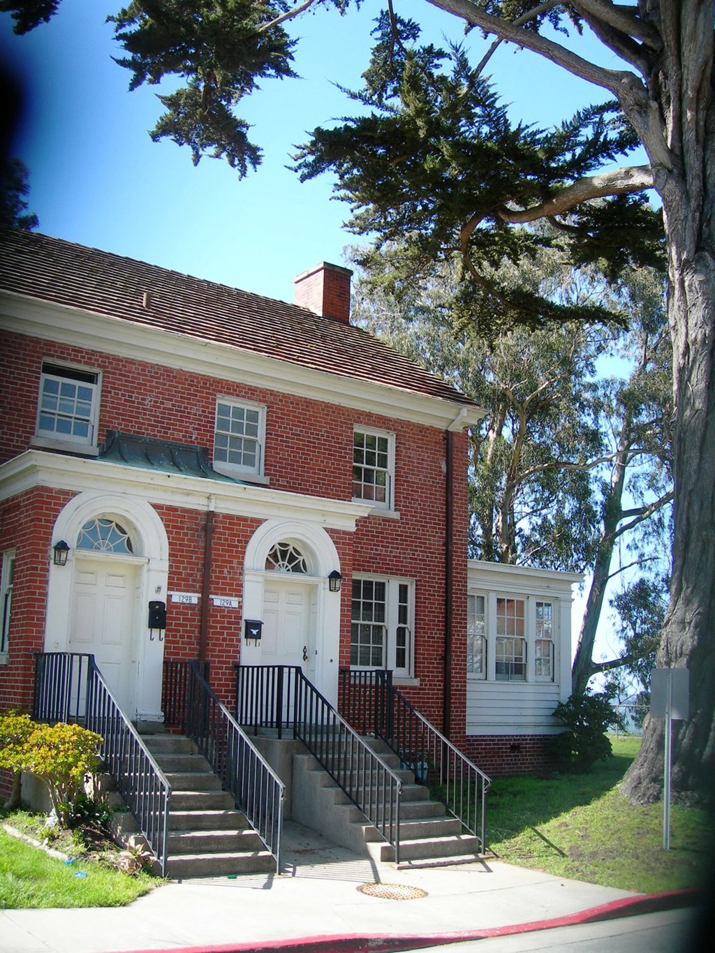 a red brick house with stairs in front of it