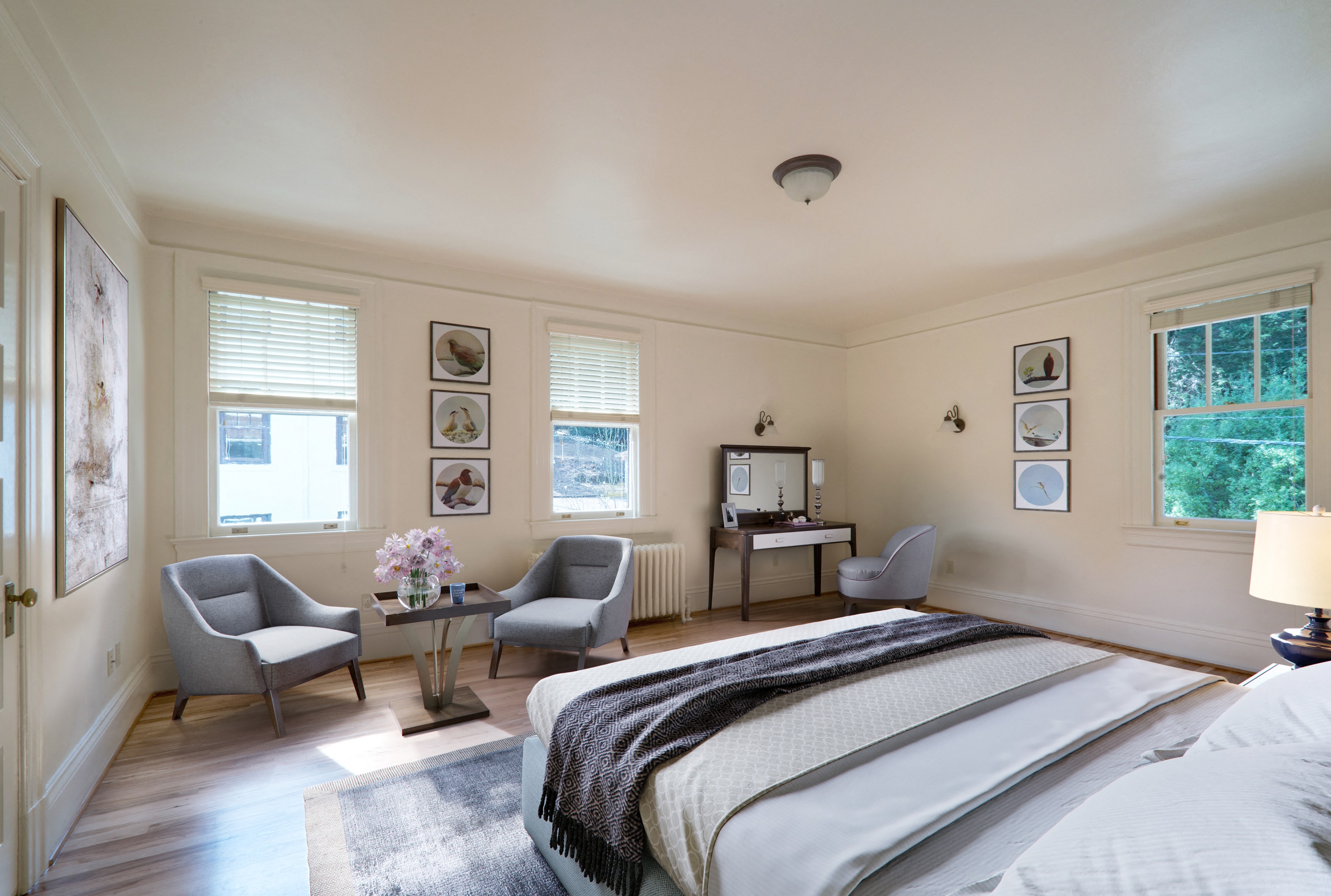 a bedroom with a bed and two chairs and a table