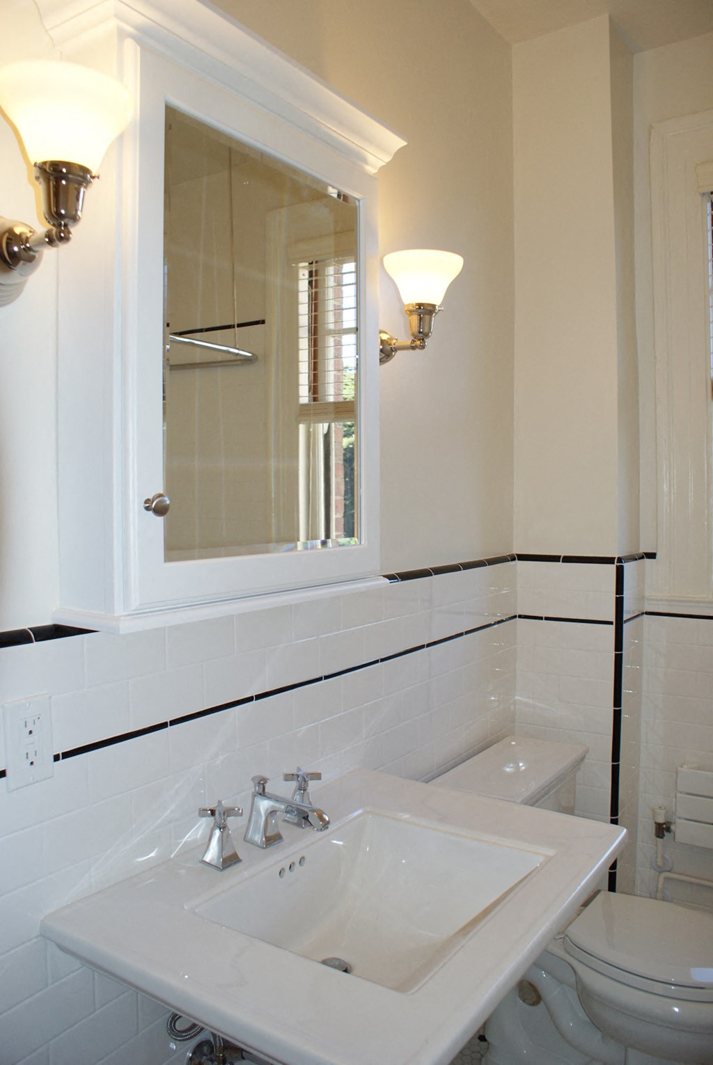 a bathroom with a sink and a mirror and a toilet