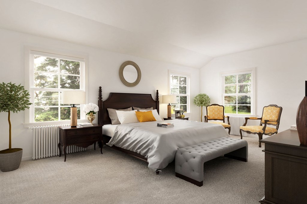 a bedroom with a bed and two windows