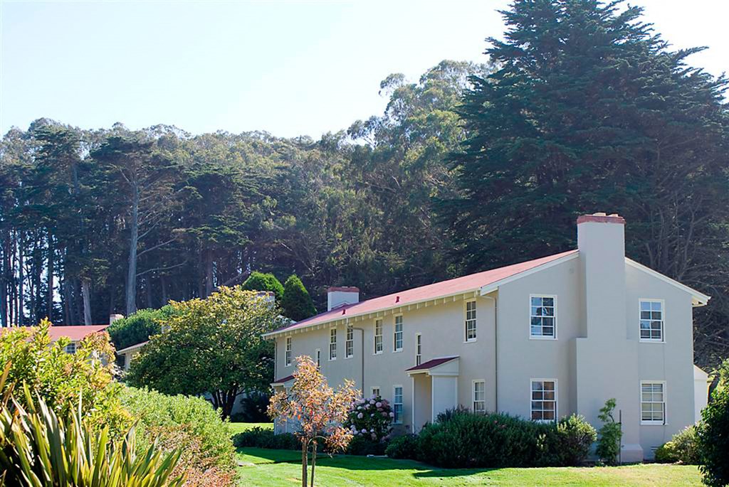 a white house with trees in the background