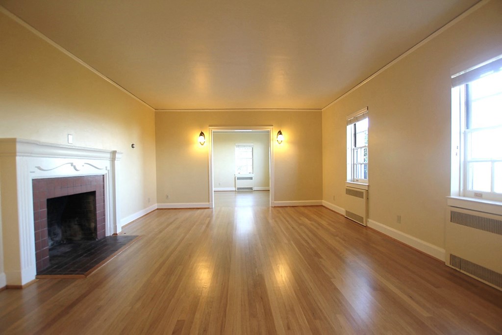 the living room of an empty house with a fireplace
