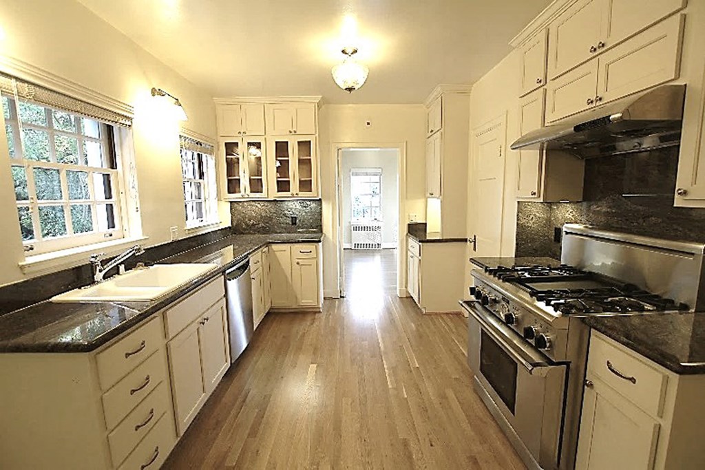 a large kitchen with a stove and a sink