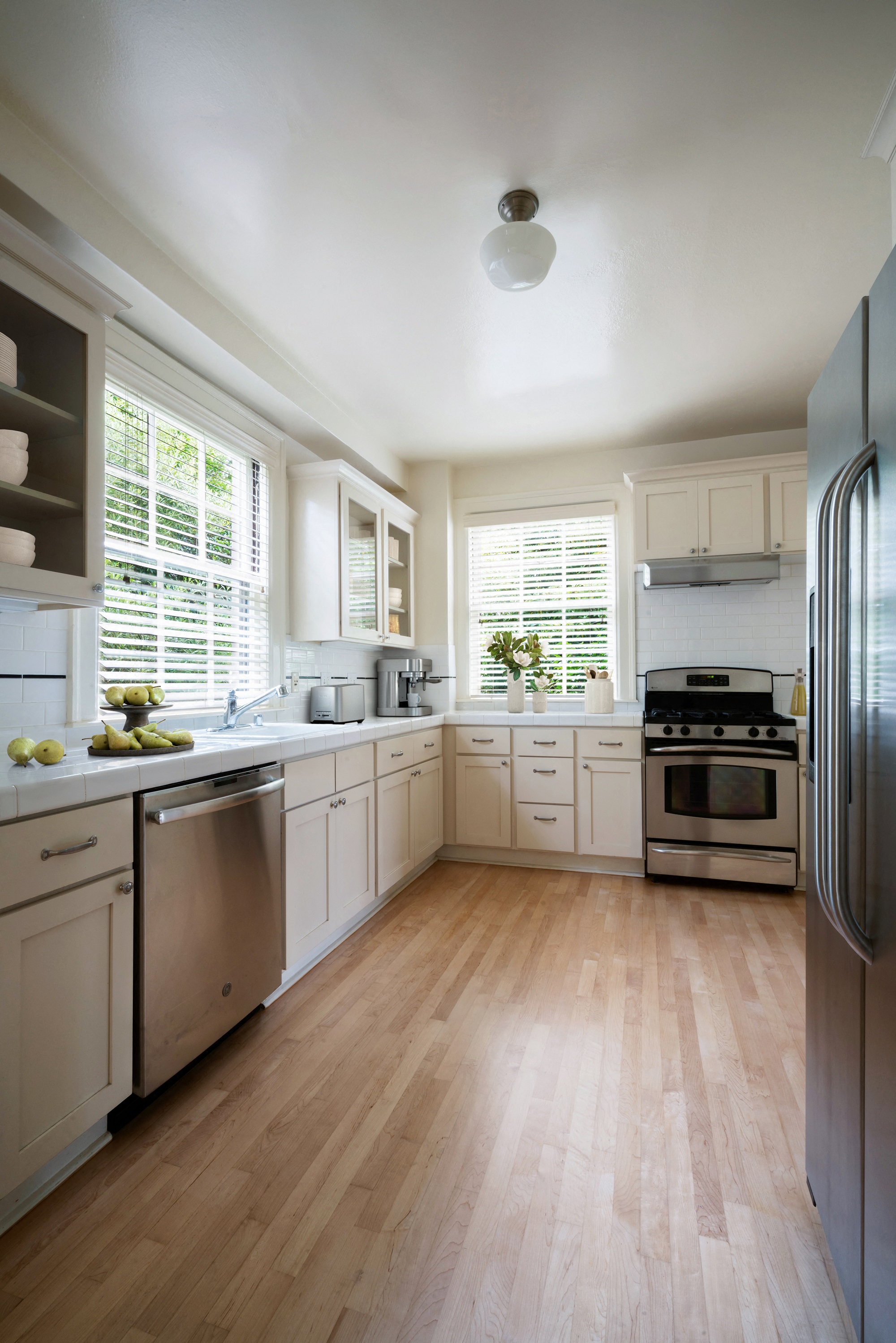 a kitchen with white cabinets and stainless steel appliances