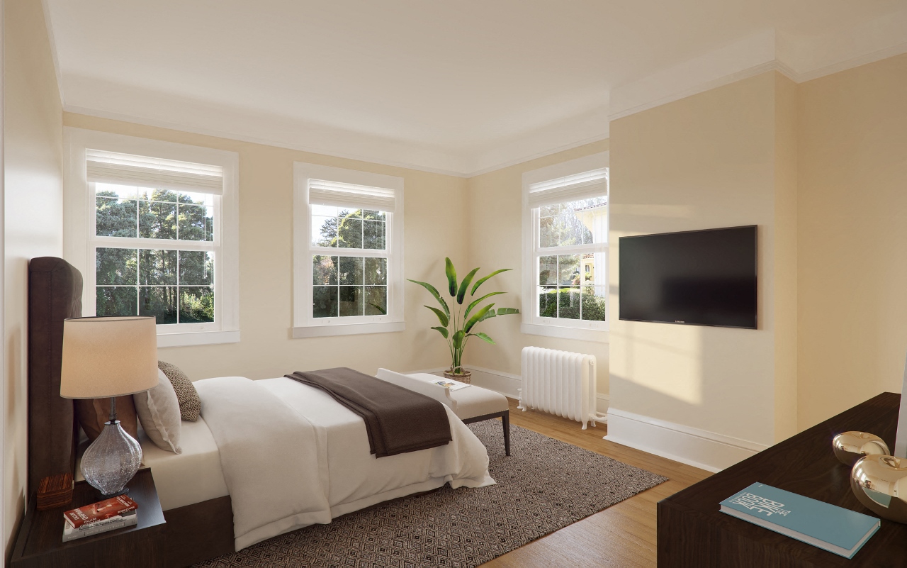 a bedroom with a bed and a tv on the wall