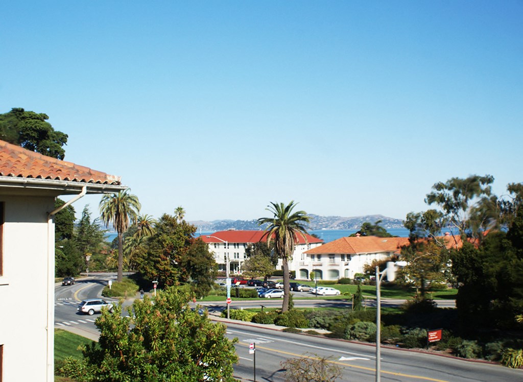 a view of a street and buildings from a balcony