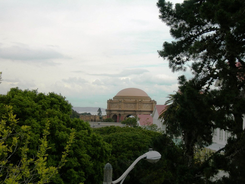 a building with a dome on top of it and trees