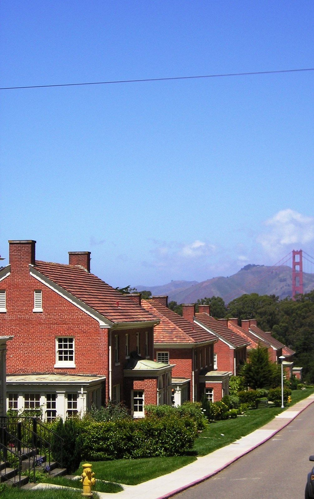 a row of houses with a view of the golden gate bridge