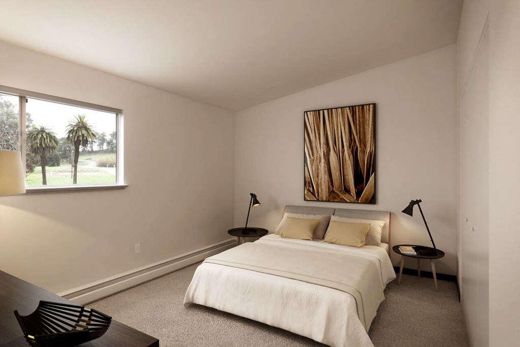 a bedroom with a bed and a large window