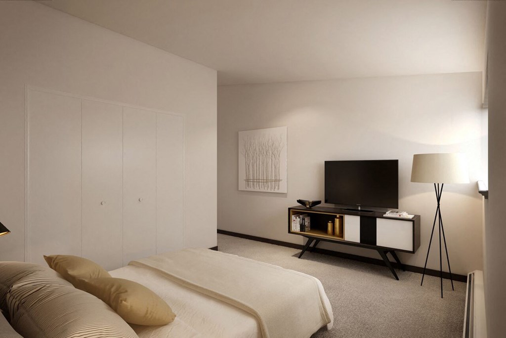 a living room with a bed and a television