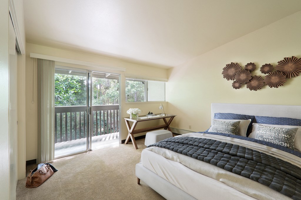 a bedroom with a bed and a sliding glass door
