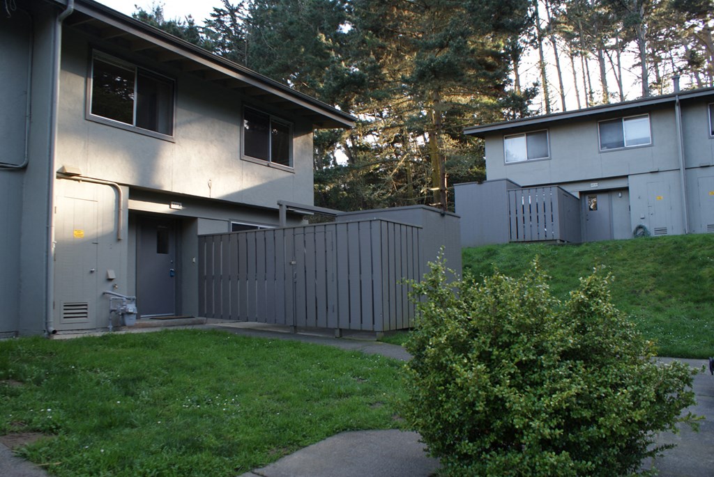 a view of a house with a fence in front of it