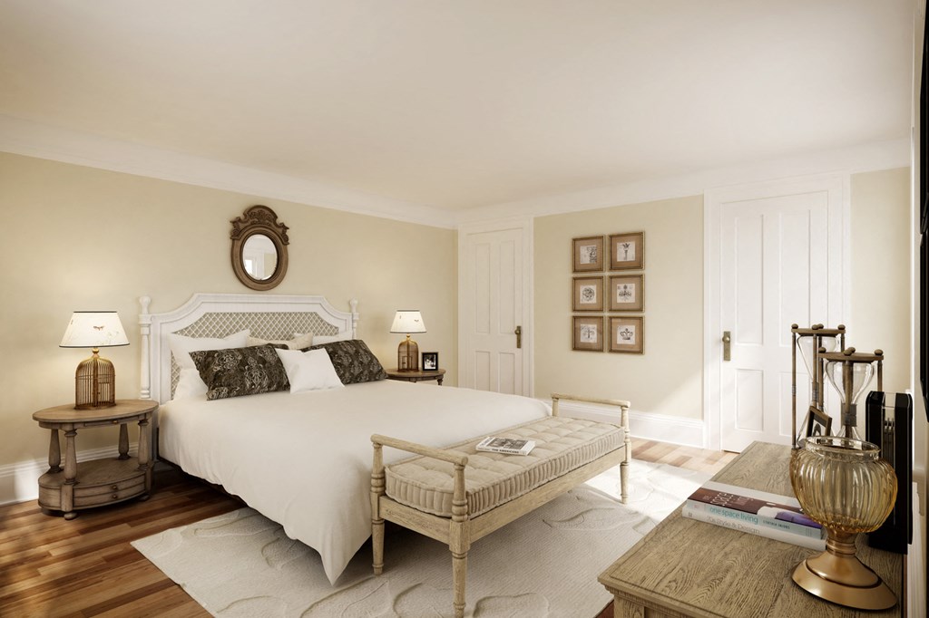 a bedroom with a white bed and a wooden floor