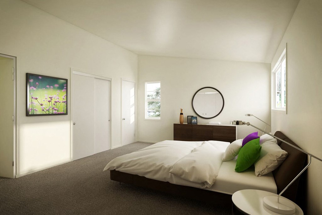 a bedroom with a bed and a round mirror