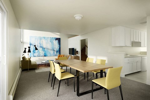 a dining room with a wooden table and yellow chairs