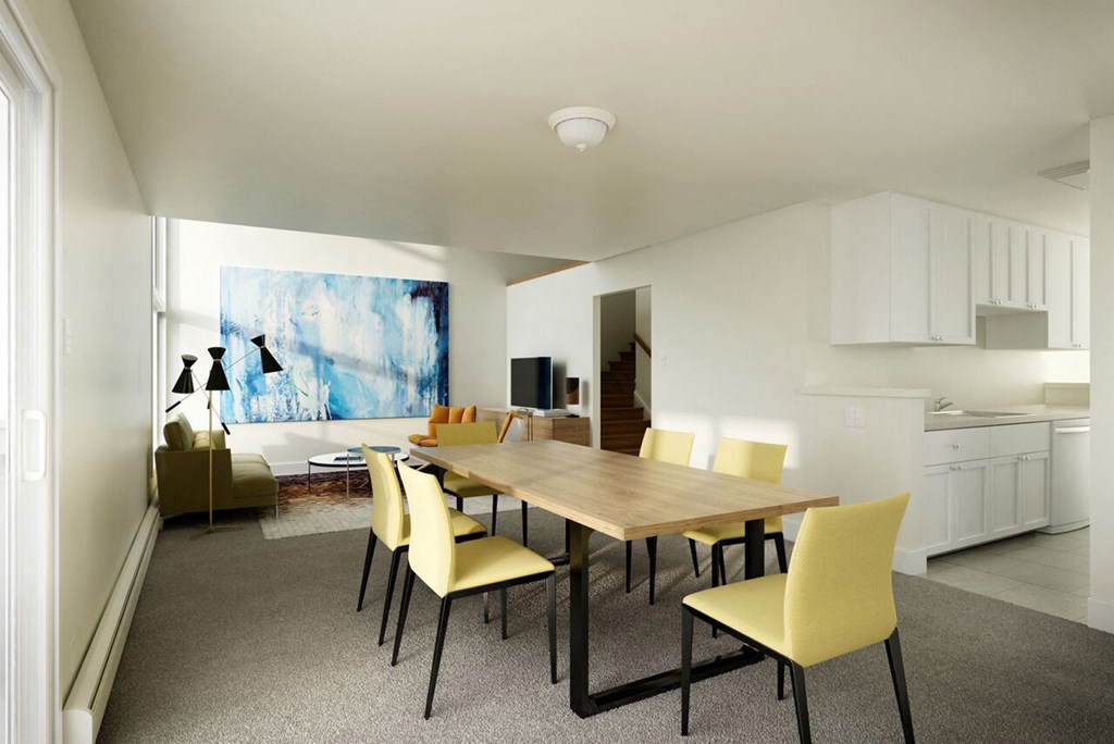 a dining room with a wooden table and yellow chairs